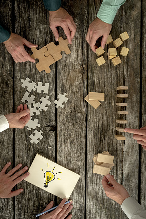 Hands building puzzles